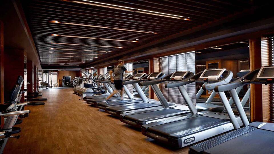 Man running on a treadmill in the hotel gym