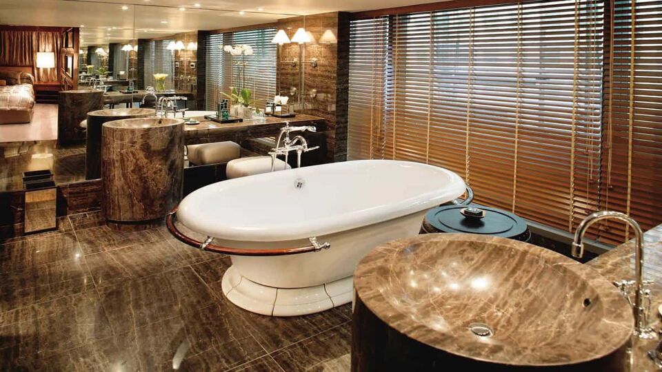 Double marble sink bathroom with a large bathtub