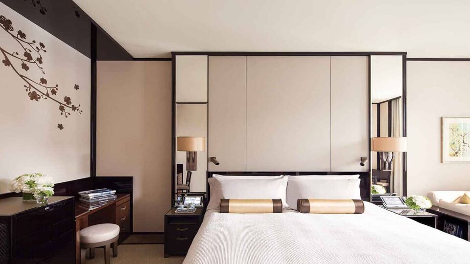 Chic bedroom with panelling behind the bed