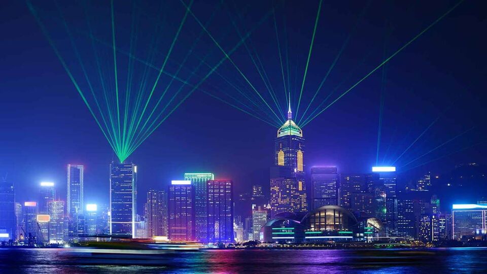 Laser show and dazzling reflections in the water of the buildings along the bay