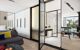 Bedroom with large cupboards, leading to the bathroom and showing reflection of the view