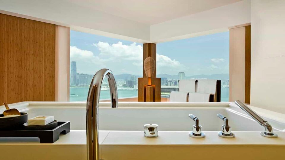 Bathroom with a large bath and two windows looking out onto the bay