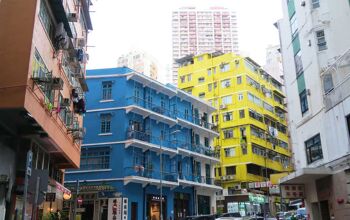 Cluster of colourful houses with bright yellow, blue and terracotta exteriors