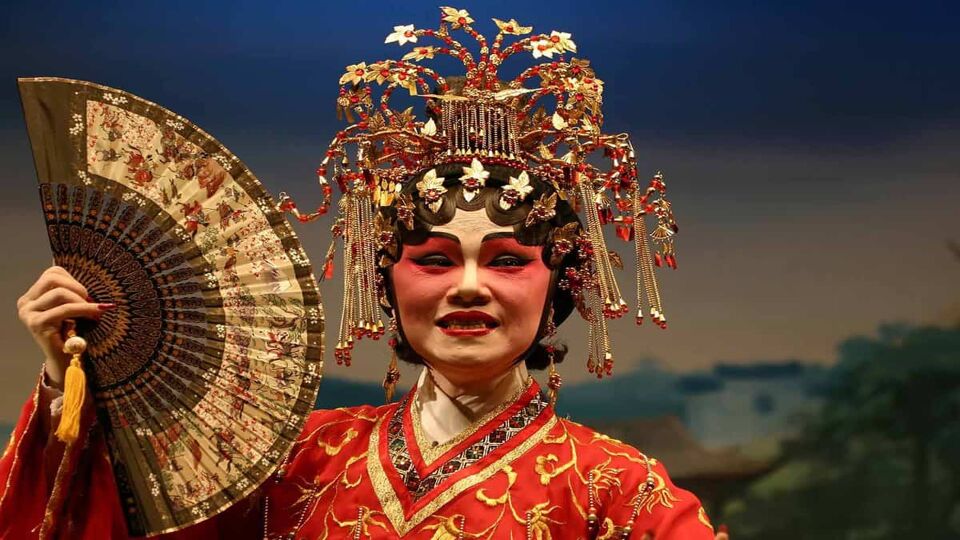 Chinese opera singer in traditional dress, headdress and makeup