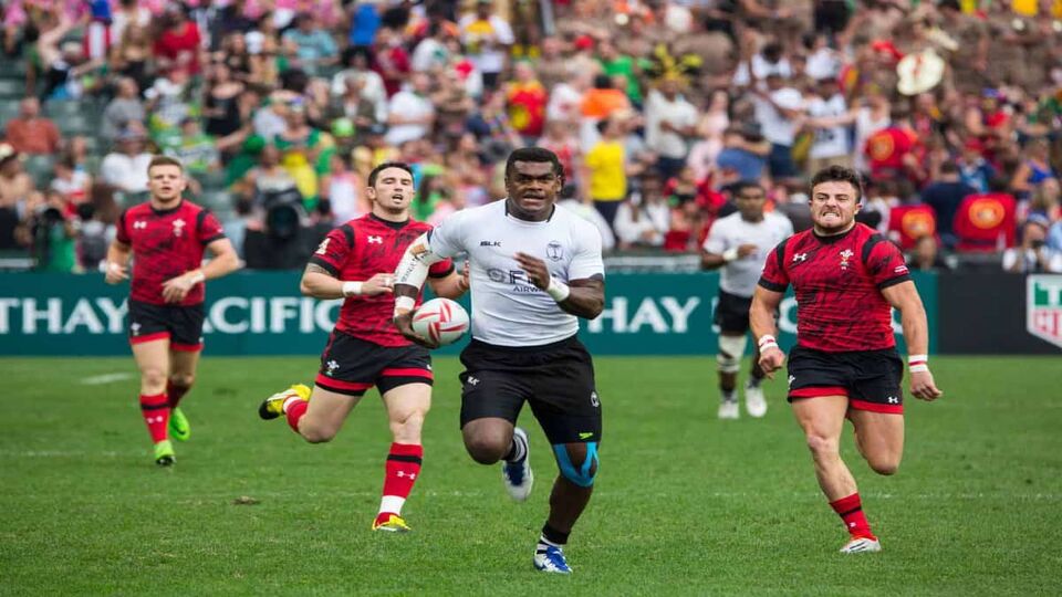 Fiji and Wales playing against each other at rugby at the Hong Kong Sevens at Hong Kong Stadium