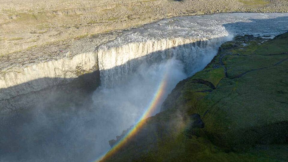 aeriel view down on Dettifoss Waterfall with a rainbow