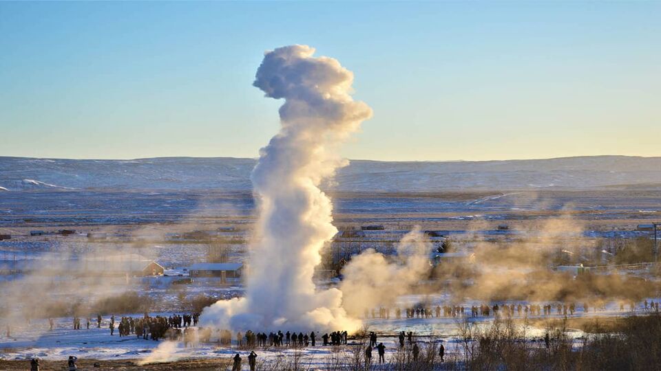 landscape of Geysir showing spout of steam