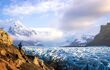 beautiful view of a glacier with hiker standing in foreground