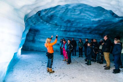 Woman giving a guide tour of an Ice cave