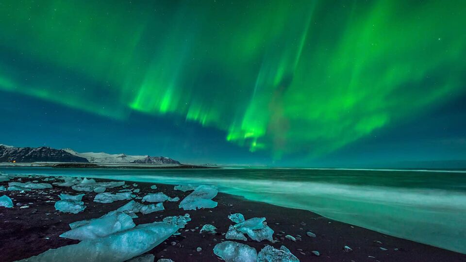 A beautiful aurora display over the ice beach near Jokulsarlon, Iceland.