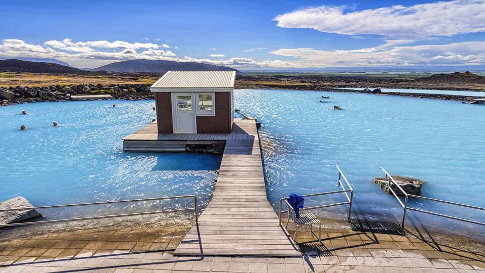summer view looking at Myvatn Baths with guard hut in the middle of the pool