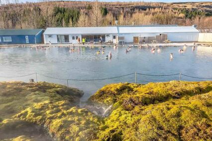Secret lagoon hot spring, public outdoor warming swimming pool, landmark of small city of Fludir, Iceland