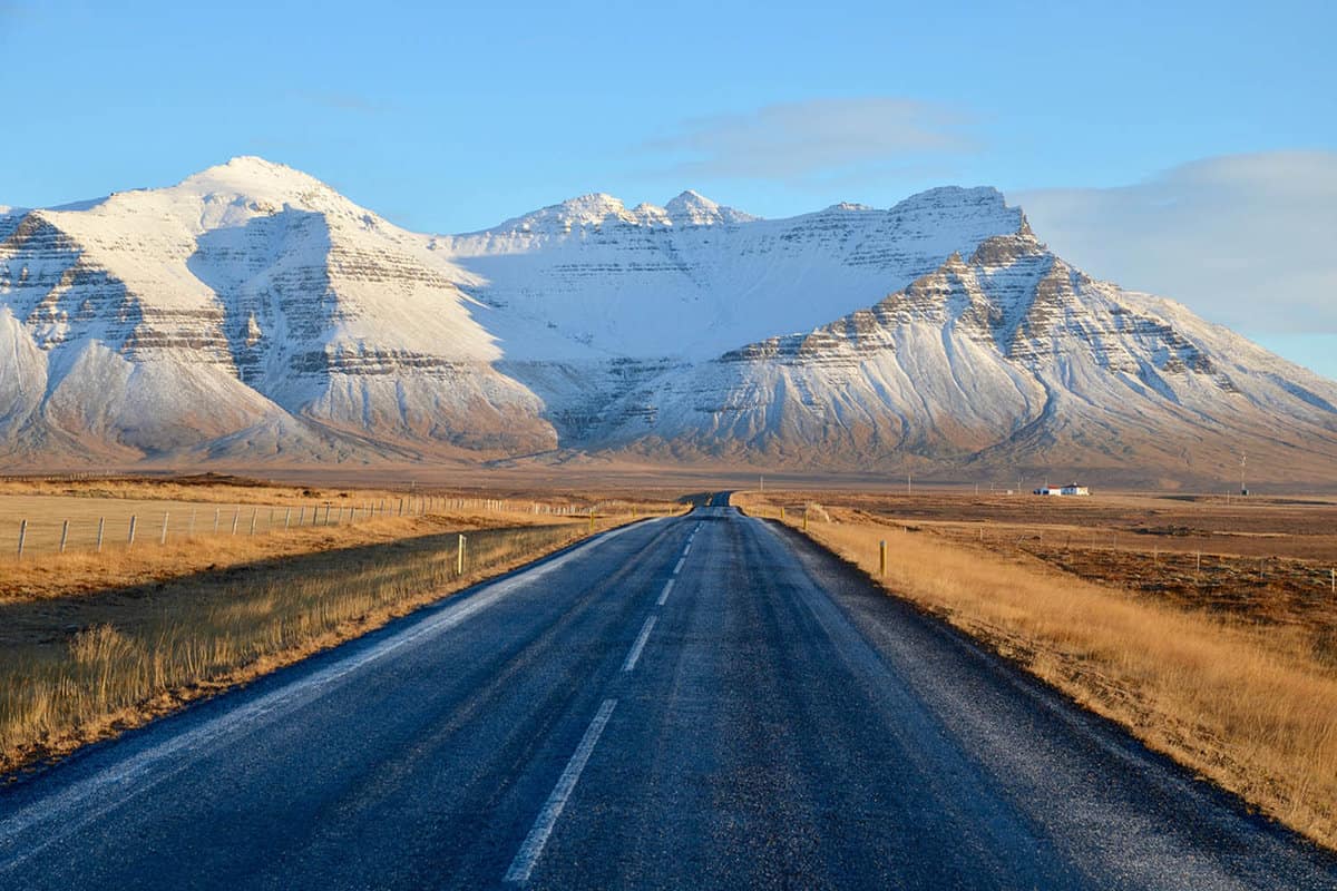 Giant snowy mountain behind a road on the Snaefellsnes Peninsula