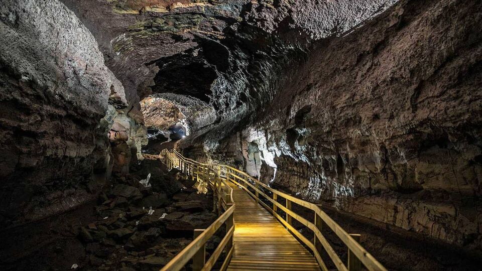 View down a yellow walkway descending into a tunnel