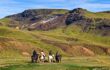 tour group riding Icelandic horses in Iceland landscape