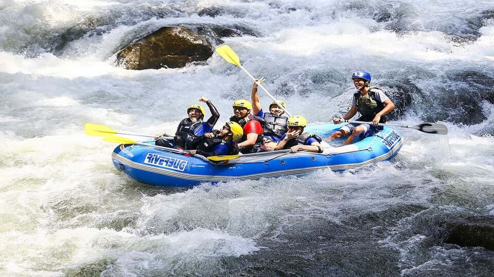 A group of extreme sports enthusiast shooting rapids with rubber boat on the river Iguazu