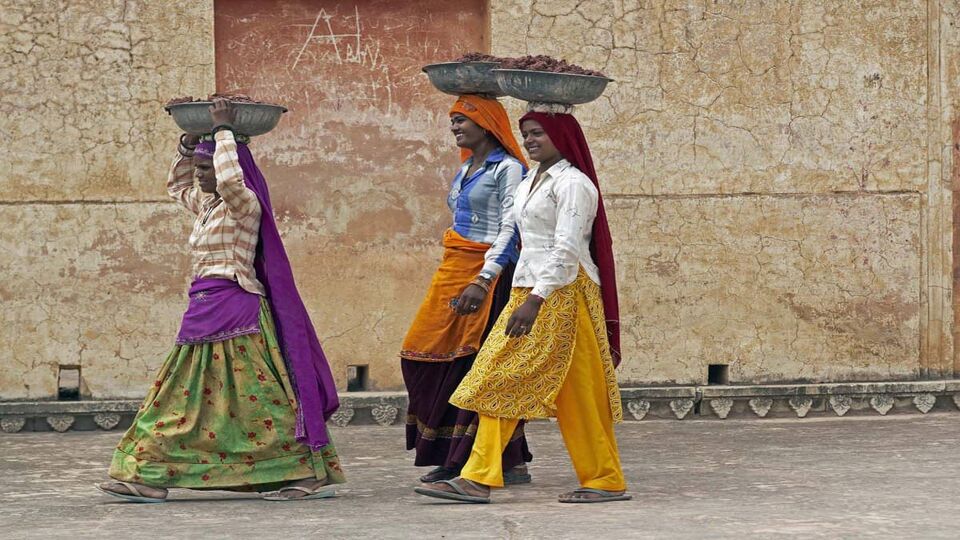 Local women walking with pots on their heads