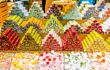 Neatly-piled triangles of vibrantly coloured Turkish delights on display in front of a market stall