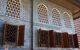 Wooden palace windows on a blue-tiled wall