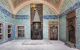 Tiled interior of palace room with domed ceiling and marble floor