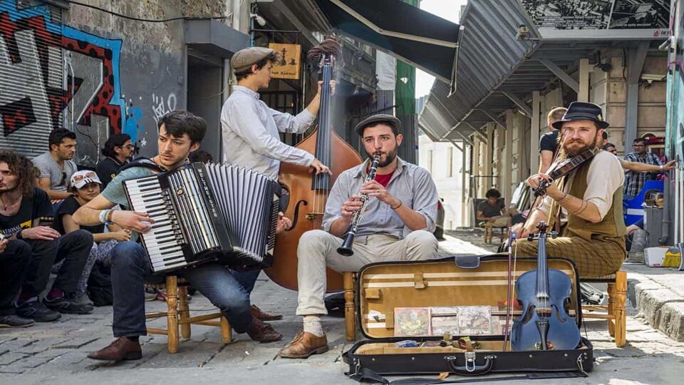 Four street musicians busking