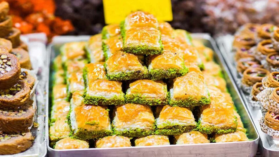 Close-up of baklava (traditional Turkish desert made of filo pastry and pistachio) piled in a pyramid