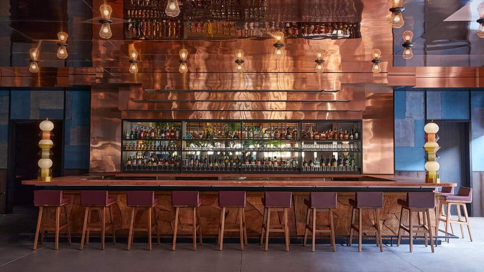Hotel bar with stools and bonze wall