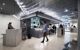 Guests arrive at reception desk in modern hotel lobby