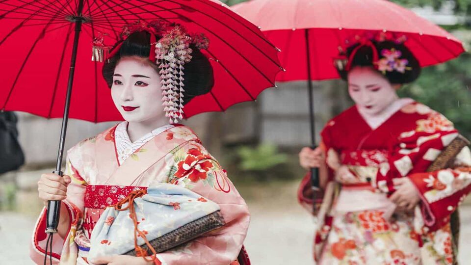Geisha women with umbrellas