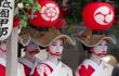Geiko lady with painted white faces and white hats
