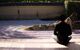 Man sits by zen garden