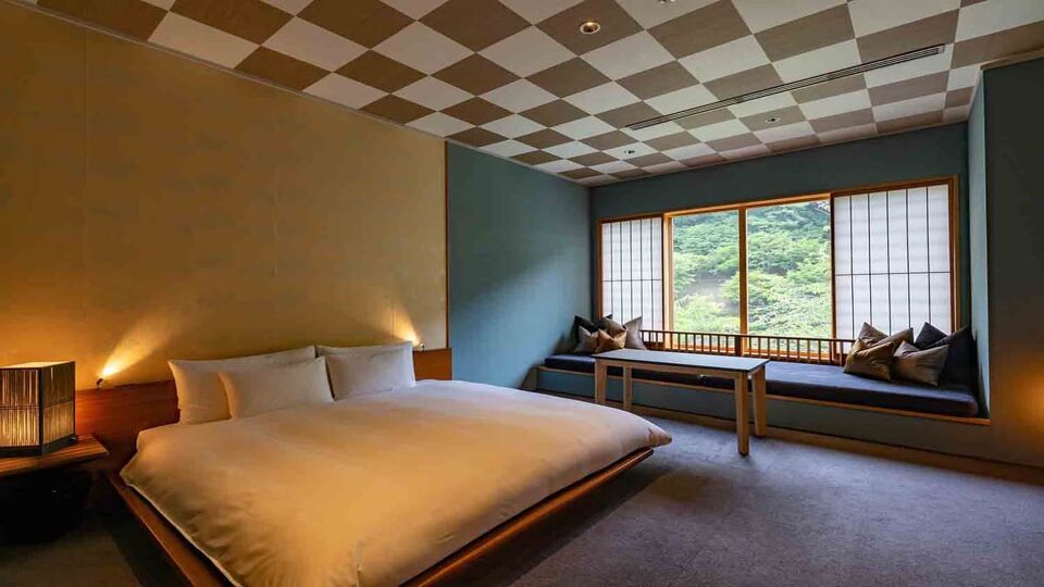 Large double room with open windows onto wildlife