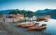 Rowing boats on the shore at Derwent Water, with dramatic mountain backdrop, Lake District, UK.