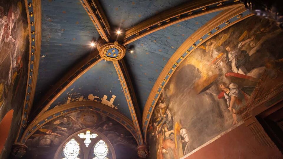 An inside view of the oratory ceiling where there the top division of the walls are painted with medieval art