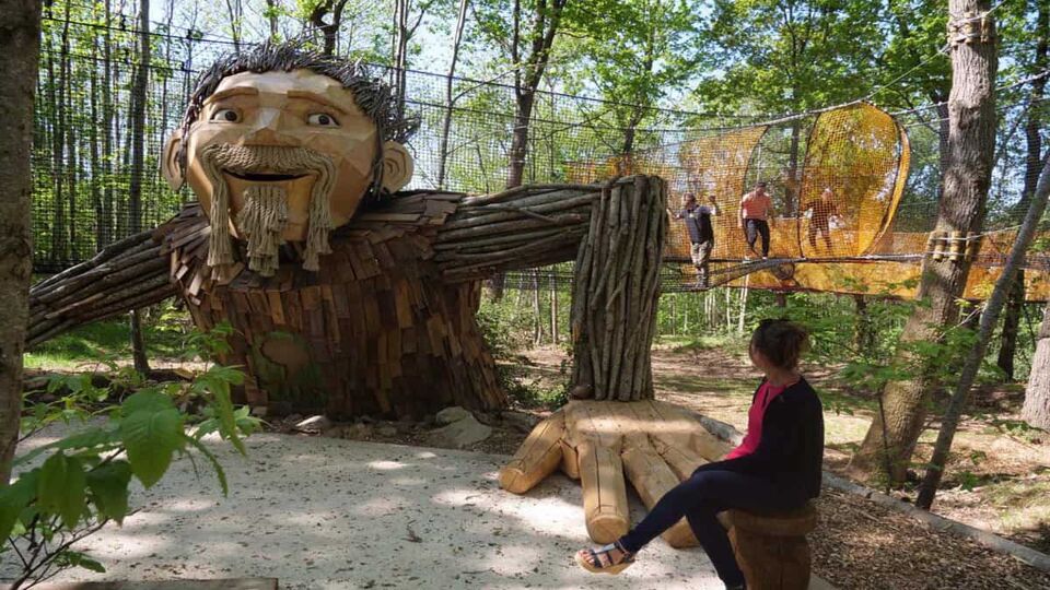 Wooden statue of man emerging from the ground