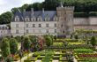 Formal gardens in front of large chateau