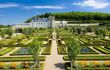 Stunning formal gardens of flowerbeds laid out in neat squares leading to chateau