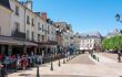 View down a pretty street in the centre of Amboise with cafes full of people