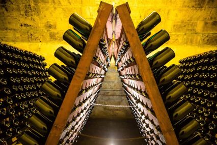 Close up of a rack of wine bottles in a cellar