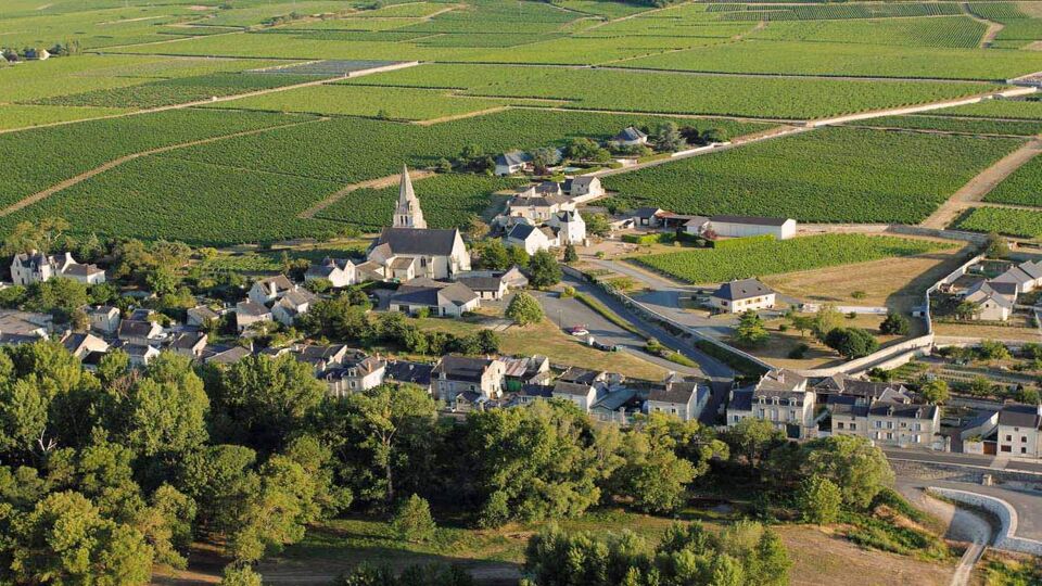 Aerial view towards a small village in the centre of vineyards