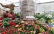 View of a floral display with a large white head statue made of straws in the middle of it