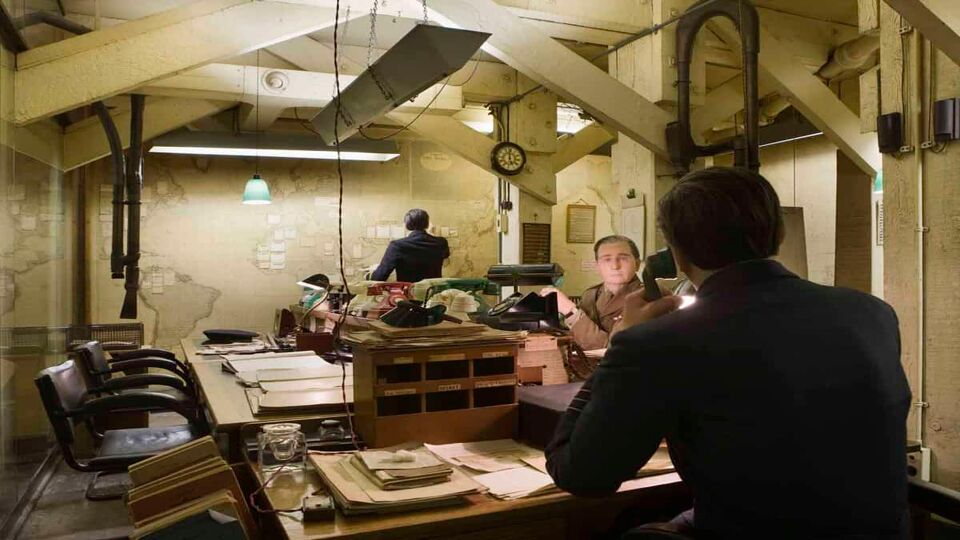 Room in the bunker showing a large map on the wall with flags/notes on