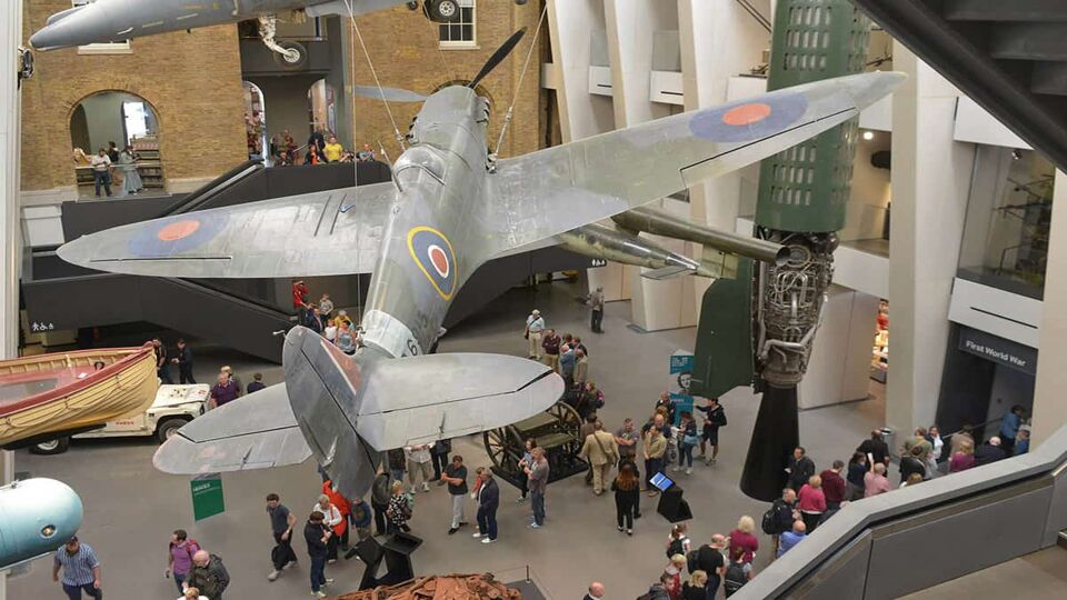 Entrance hall to a war museum with a historical warplane during the daytime