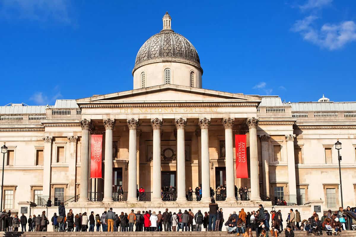 Exterior view of the front of the gallery during the daytime with queue pf people outside