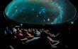 Tourists experiencing a show inside the Planetarium of the Royal Observatory Greenwich