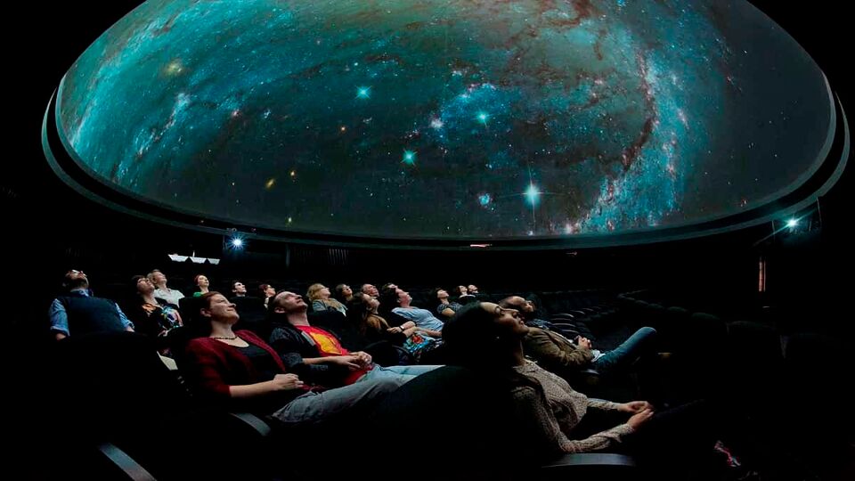 Tourists experiencing a show inside the Planetarium of the Royal Observatory Greenwich