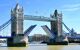 Tower Bridge's famous gate opens on River Thames during summer. London, England.
