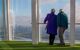 Couple staring out of the window from observation deck of The Shard