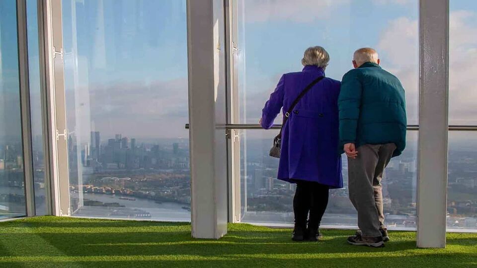 Couple staring out of the window from observation deck of The Shard