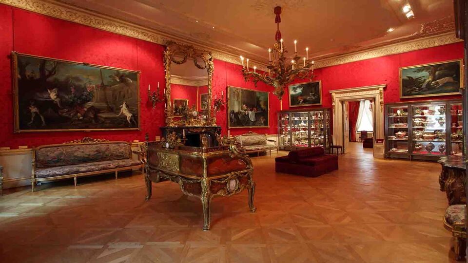 Room in the Wallace Collection Museum displaying fine art paintings on the walls